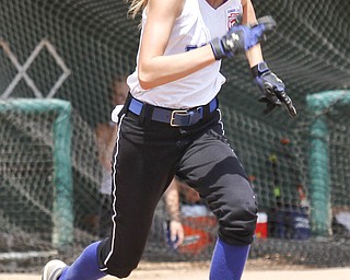 Kat Wilson drops her bat and runs for first after hitting.