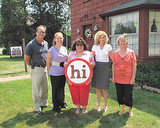 Assistant director of TourismOhio, Pat Barker, recently spent a day in Columbiana touring the sites and surrounding countryside. Barker, second from right, stands in front of Shop On Main on North Main Street. Others, from left, are Rob Schwartz, tourism director; Crystal Boggs, executive secretary of the Columbiana Area Tourism Bureau; Rose Conrad, backup director; and, far right, Barb Farrand, tourism director. After Barker’s tour, which was facilitated by Jay Groner, a Columbiana area tourism director, high tea was observed at Barley Twist Antiques and Tea Room on North Main Street. The tourism board then conducted a meeting and took the opportunity to start the development of a long-term relationship with the TourismOhio office. Barker was able to provide information on tools the board could use for the development of Columbiana’s tourism.