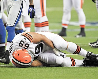 Cleveland Browns nose tackle Scott Paxson (69) holds his knee after a play during the first half of a preseason game against the Lions in Detroit.