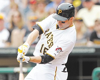 Pittsburgh Pirates’ Neil Walker hits a single in the first inning of a game against the San Diego Padres on Sunday in Pittsburgh. Walker went 5-for-5, driving in two runs and scoring two runs as the Pirates won 11-5.