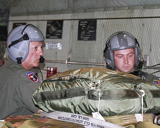 ROBERT K. YOSAY | THE VINDICATOR..Doing a last minute check on the payload that will be dropped on the Ravenna arsenal is MSgt Bob Zanni and SRA Marcus Watson ..-30-