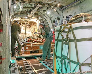 ROBERT K. YOSAY | THE VINDICATOR..Doing a last minute check on the payload that will be dropped on the Ravenna arsenal is Sgt James Hudson .. farthest from camera and MSgt Bob Zanni ..-30-