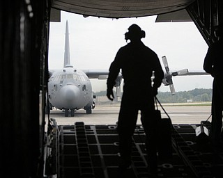 ROBERT K. YOSAY | THE VINDICATOR..Back on the ground SRA Marcus Watson opens the rear hatch as a C130 H follows in formation - -30-