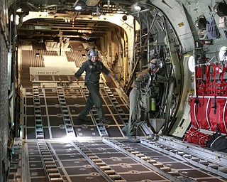 ROBERT K. YOSAY | THE VINDICATOR.. cleaning up straps in the back of the C-130 after it dropped a 3000 lb payload is SraMarcus Watson and Sgt James Hudson -30-