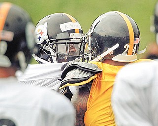 Pittsburgh Steelers wide receiver Antonio Brown, left, and defensive back Ike Taylor (24) grab each other during a confrontation after a play during training camp in Latrobe, Pa. Brown and Taylor have gotten into two scuffles during recent practices.
