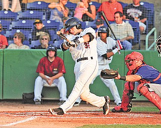 Scrappers batter Jeremy Lucas drives the ball to the outfield during Wednesday’s game against Auburn at Eastwood Field. Among those watching are Doubledays catcher Spencer Kieboom and umpire Mike Wiseman.