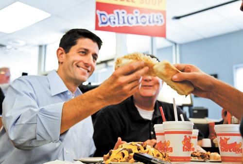 Paul Ryan, the Republican vice presidential candidate, hoists a hot dog at a Warren restaurant. Ryan spent about 30 minutes at the Hot Dog Shoppe on Thursday.