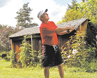 Leland Musguire chips in the backyard of his home in Pulaski, Pa. Musguire has had many hobbies, ranging from boxing to male dancing, and now he is up for Greatest Golfer.