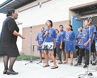 The Williamson Elementary School Voices of Hope Choir sings a song about hope Sunday during the Williamson Back To School Rally and Block Party. About 300 people attended the event at the school.