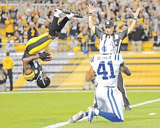 Steelers wide receiver Antonio Brown flips into the end zone over Indianapolis Colts defensive back Antoine Bethea for a touchdown in the first quarter of their preseason game Sunday night in Pittsburgh.