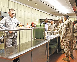 Schmidt gets his share of chow at the Boy Scout camp during his tour of the workplace.