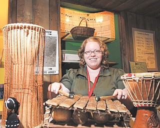 Traci Manning, curator of education at the Arms Family Museum on Wick Avenue in Youngstown, demonstrated African musical instruments in the hands-on portion of the museum during an open house for teachers Tuesday.