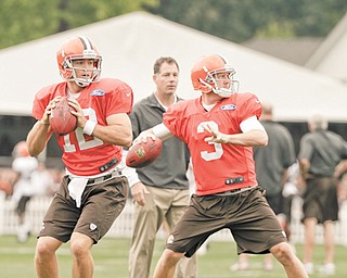 Cleveland Browns quarterbacks Colt McCoy, left, and Brandon Weeden (3) practice Tuesday in Berea. Despite being delegated to the backup role, McCoy says he is happy in Cleveland.