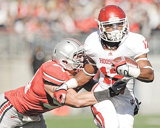 Indiana’s Stephen Houston is taken down by Ohio State’s John Simon during a game in Columbus. Simon, a Cardinal Mooney grad, and his fellow defensive linemen may not be as well known as the offensive players, but they will determine how rapidly the Buckeyes can erase an awful 2011.