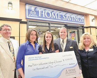 Youngstown State University’s Williamson College of Business Administration recently received a check for $6,000 from the Home Savings Charitable Foundation. Dr. Raymond Shaffer, chairman of the accounting department, said the funds will go to three YSU students majoring in accounting and finance: Sarah Kluska, Kenneth Mylar and Rachel Roberts. Each will receive a $2,000 scholarship. From left to right are Shaffer, Roberts, Kluska, Mylar and Jeanne Watson-Antol, retail manager II, at the Home Savings YSU Office.