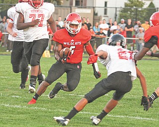 Tommy Kimbrough (6) of Struthers cuts past Campbell’s Corey Hamilton (21) on his way to a touchdown in the second quarter of Thursday’s game in Struthers. The Wildcats came out on top of the rivalry with the Red Devils, 26-20.