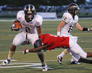 ROBERT  K.  YOSAY  | THE VINDICATOR --..Breaking a tackle on a long run in the second quarter is Hardings #2 Jalyn Powell as Fitchs #9  Keith Lawrence  tries to wrap him up .behind him is #12   Kevin Vingle ( harding 0..Warren Harding @ Austintown Fitch -Fitch Stadium...(AP Photo/The Vindicator, Robert K. Yosay)