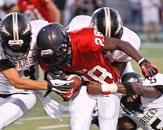 ROBERT  K.  YOSAY  | THE VINDICATOR --..No Where to go as Fitchs #28  Tyreese Anderson  is tackled by three Raiders   #14  Jimmy Rumple - #2  Aaron Quails andd #5  Lyndal Kimble for no gain in the second quarter..Warren Harding @ Austintown Fitch -Fitch Stadium...(AP Photo/The Vindicator, Robert K. Yosay)