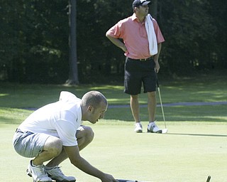 William d Lewis the vindicator Patrick Marloweines up a putt Friday at Mill Creek. Looking on is Scott Porter