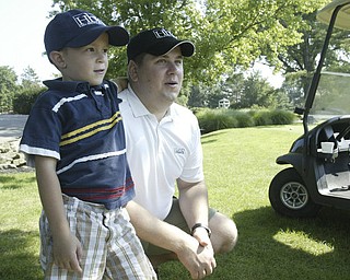 William D. Lewis The Vindicator  In the gallery at Trumbull CC Saturday are Nick Odille and his son Ian, 5.