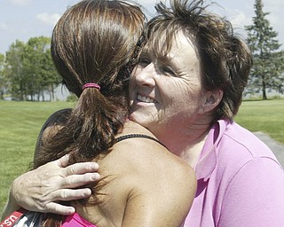 William D. Lewis The Vindicator Womens winner Lori Bowden , RIGHT, gets a hug fromKathy Garritano after winning at Lake Club Sunday.