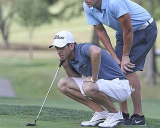 William D. Lewis The Vindicator Athony conn, left, and his caddy line up a putt at Lake Club Sunday.