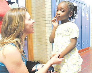 Paris Yanno shares a moment with 4-year-old Bethany Boykin, a student at Heart Reach Ministries day care. Yanno is the ministries director at Heart Reach.