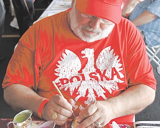 Larry Kozlowski of Pittsburgh decorates eggs with melted wax, a Polish tradition celebrated at Easter, at the fourth annual Polish Day on Sunday in Austintown.