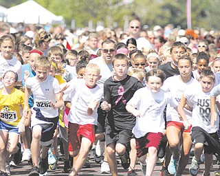 Hundreds of children take off running during the first Kids Run Sunday at the Covelli Centre in Youngstown. The Kids Run was one of three races offered at the third annual Panerathon, which benefits the Joanie Abdu Comprehensive Breast Care Center at St. Elizabeth Health Center.