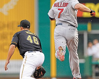 St. Louis Cardinals’ Matt Holliday (7) beats out an infield single as Pittsburgh Pirates first baseman Garrett Jones gets the late throw in the first inning of the baseball game Monday in Pittsburgh.