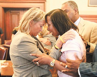 Rebecca Doherty, chief of the criminal division of the Mahoning County Prosecutor’s office, left, and Shirlene Hill, mother of murder victim Jamail Johnson, embrace after a jury on Wednesday convicted Columbus Jones Jr. on all counts.