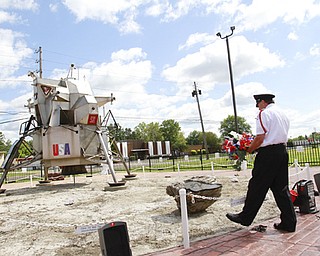 Cortland resident Garey Watson of the Trumbull County Honor Guard places a wreath at the Apollo 11 lunar module replica site on Parkman Road Northwest in Warren. The replica was built a decade ago to honor Neil Armstrong, the first man to walk on the moon, who died Saturday at age 82. A memorial for Armstrong was Wednesday at the site.