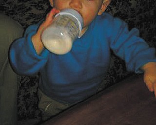 Jackson Reed Straley of Tallmadge, grandson of Wayne and Sheryll Straley of North Jackson, drinks his bottle in style. Photo sent in by Wayne Straley.