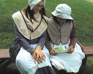 Cousins Karen Betts of Austintown and Rachel Seigfried of Kent are dressed as Shaker girls at the Hancock Shaker Farm.
