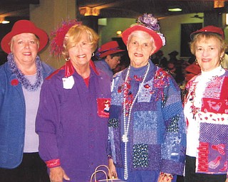 From left, Marilyn Burrows, Peggy Potts, Harriet Deeds and Sally Reedy are resplendent in red hats and shades of purple. Photo sent in by Harriet Deeds of Youngstown.
