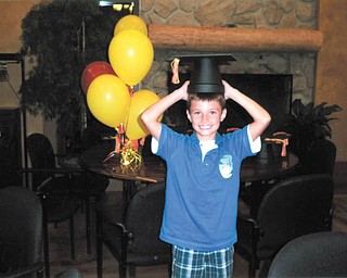 Dominic Mongiardo of Louisville, Ohio, tries on a "hat" that's really one of the centerpieces for his cousin's graduation party. Photo submitted by Mary Hager of Columbiana.