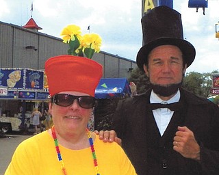 Debbie Riggs of East Palestine, who sent in this photo, bought this flowerpot hat about five years ago at the Ohio State Fair. She models it here with "Abe Lincoln" at the state fair.