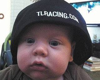 Brady Ford Hodge wears his dad's racing hat. Photo sent in by grandparents Ron and Cathy Hinderliter of Canfield.