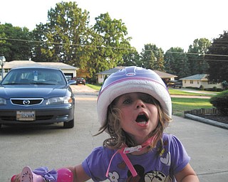 The bike helmet may be way too big, but at least she's thinking about safety! Photo sent in by Bob Ohl.