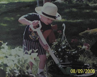 J. Ferrett of Hubbard sent in this photo of grandson Bryan sporting his Amish hat while planting flowers.