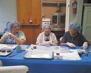 Ladies of the Simon Road Church of God in Youngstown sport some head coverings for Easter-Egg-making time. Photo sent in by Sheree Upright.