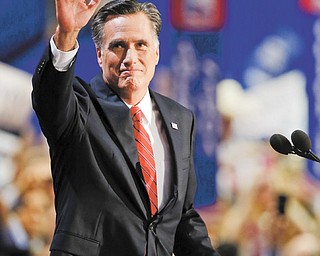 Presidential nominee Mitt Romney waves to delegates before speaking at the Republican National Convention in
Tampa, Fla., on Thursday.