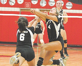 Canfield’s Anastasia Cook (6) and Jacqueline Cook (4) converge on the ball during a volleyball game Thursday
against Girard at Canfield High School. The Cardinals downed the Indians, 3-1.