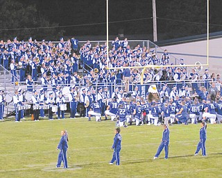 The Hubbard High football team kneels in front of the band as the alma mater is played following the Eagles’ 56-0 shutout win over Cleveland Collinwood