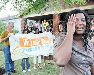 Ajeenah Seifullah is overcome with joy Thursday evening after being presented with a surprise: a house for her family. The house on East Florida Avenue in Youngstown was donated by a church member, and other members from Victory Christian Center in Liberty helped to fix it up.