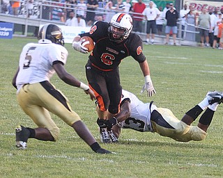 NICK MAYS l THE VINDICATOR.(6) Tyler Drass of Howland tries to get away from (13) Lebrandon Watson as (5) Lyndal Kimble comes up to help during the first quarter in Howland. - harding vs howland at howland Friday 08312012