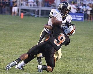 NICK MAYS l THE VINDICATOR.(9) Trey Bryarly of Howland makes the tackle as (2) Jalyn Powell tries to get away during the second quarter in Howland. - harding vs howland at howland Friday 08312012