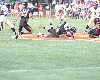 NICK MAYS l THE VINDICATOR.(41) Ralph Robinson of Howland and (7) Mik'quan Dorsey of Harding fight for the ball on the opening kick off in Howland. - harding vs howland at howland Friday 08312012