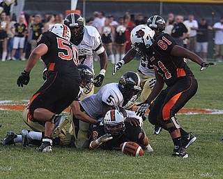 NICK MAYS l THE VINDICATOR.(6) Tyler Drass of Howland fumbles the ball and team mate (61) Jack Finch recovered it during the first quarter in Howland. - harding vs howland at howland Friday 08312012
