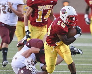 ROBERT K. YOSAY | THE VINDICATOR..Mooneys #10 Justus Ellis-Moore breaks through the line and Bdm#8 Ryan Savage as Mooney #14 Marcus Penza Looks on - he gained a first down and 35 yards during first quarter action..Bdm @ Mooney - Stambaugh Stadium... - -30-..